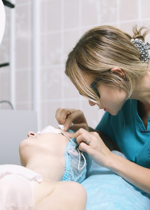 Beautician in a skin clinic with patient Beautician in a skin clinic with patient